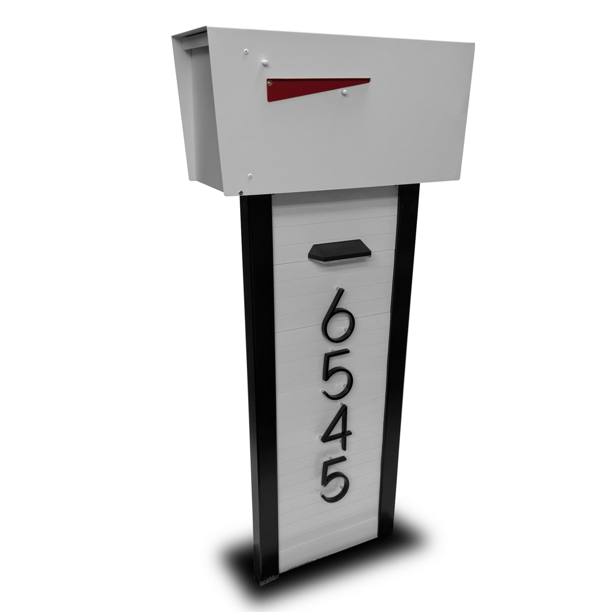 A modern aluminum mailbox on a freshly reset post